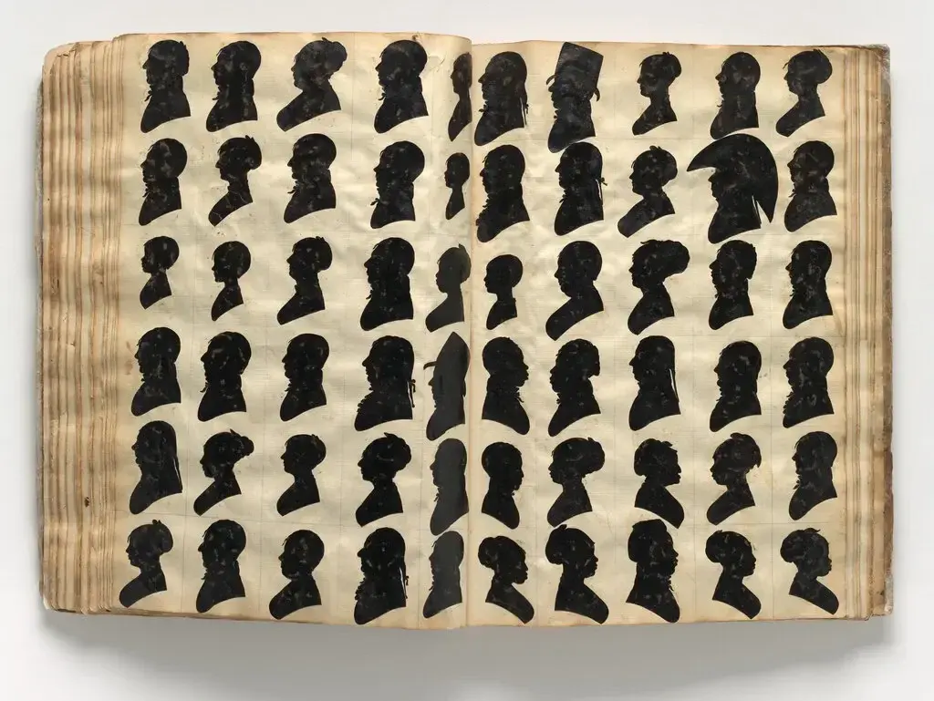 Bound portrait album from circa 1800 displaying rows of cut-paper silhouette profiles in a grid